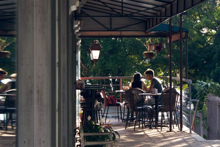 Couple dining in at a Park City restaurant on the wooded balcony