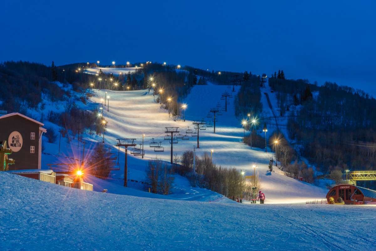 Ski slopes at night light up by lights, view from the best-located home in Park City. 