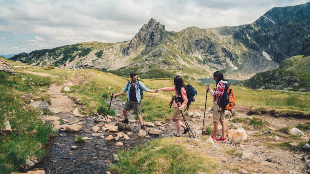 3 People Hiking, Mountains in Background